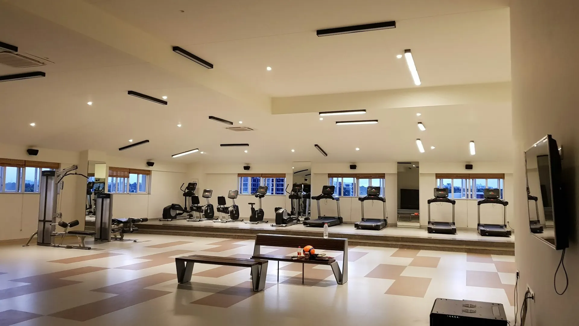 The gymnasium at L&T Island Cove featuring a variety of fitness equipment, bright lighting, and a spacious interior for a comprehensive workout experience.